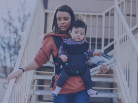 Woman with a baby walking down stairs